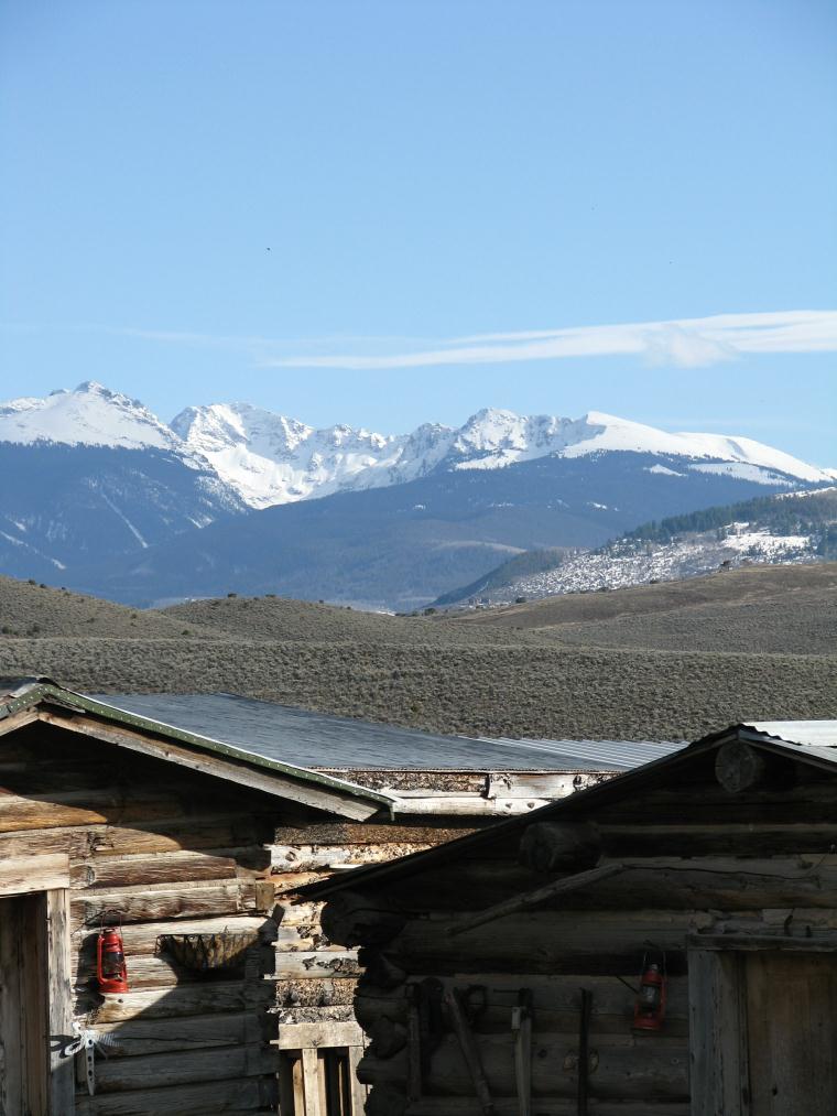 Cabins in the foreground with snowy mountains in the background